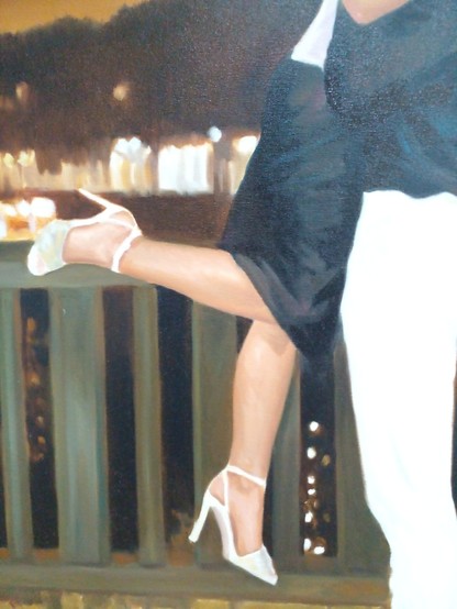 a close-up of their legs and the railing of the balcony