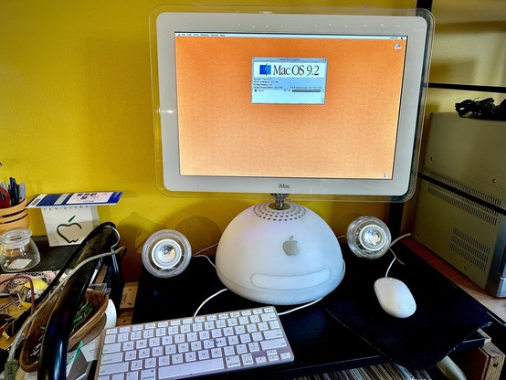 Circa 2002 iMac with original speakers and non-original (but still Apple) keyboard and mouse, running Mac OS 9.2.