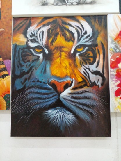 a painting of a tiger, facing the viewer, just the tiger's face