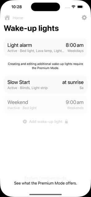 Video of my 'Wake Up Light' app premium screen, featuring a bedroom scene. The scene features a neatly made bed, a nightstand with a glowing lamp, a bookshelf, and wall-mounted pictures casting a warm light. Below the image, a list highlights 'Explore all Premium Mode features' including Multiple Lights per Alarm, More gradients, Multiple wake-up lights, and Sunrise and sunset. At the bottom, there's a call-to-action offering the premium feature set as a subscription.
