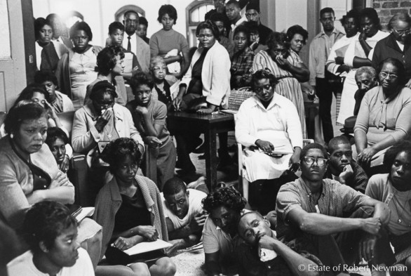 Civil-rights workers listen to the news of president Kennedy's assassination, St. Helena Island, South Carolina. This is inside Frogmore Center, a retreat used by the Southern Christian Leadership Conference (SCLC).