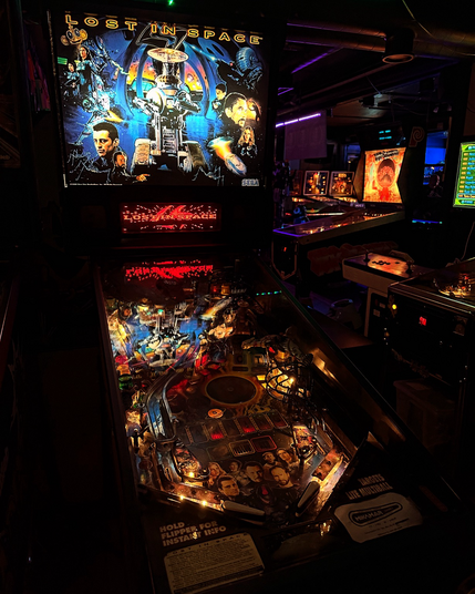 Lost in space pinball machine, front left view. Other games are seen in the background.