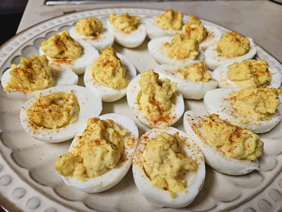 Plate of deviled eggs dusted with spicy Hungarian paprika.