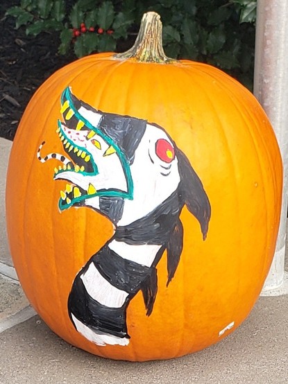 Pumpkin with the surface painted to display one of the black and white striped giant sand worms from Beetlejuice.