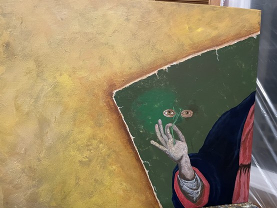 A painting in progress. The background is a mottled yellow, from the right it looks like a damaged old painting is partially visible. The part of the painting that is visible has a hand coming out of a blue and red robe holding a stem with two eyes as commonly associated with Saint Lucia.