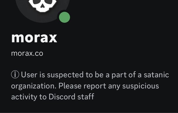 Discord profile with status text that says “User is suspected to be a part of a satanic organization. Please report any suspicious activity to Discord staff”