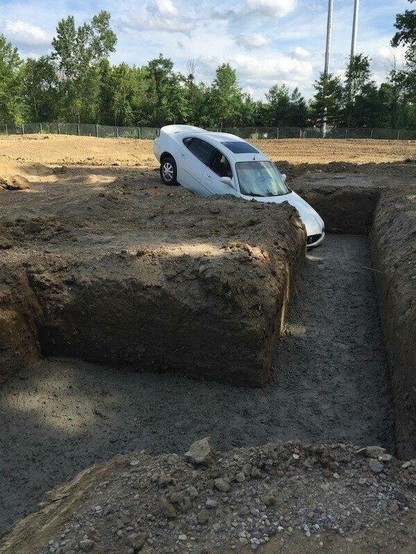 Car in tipping into dirt maze of some sort