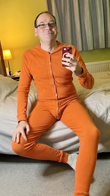 Hairy gay guy wearing an orange Nasty Pig union suit