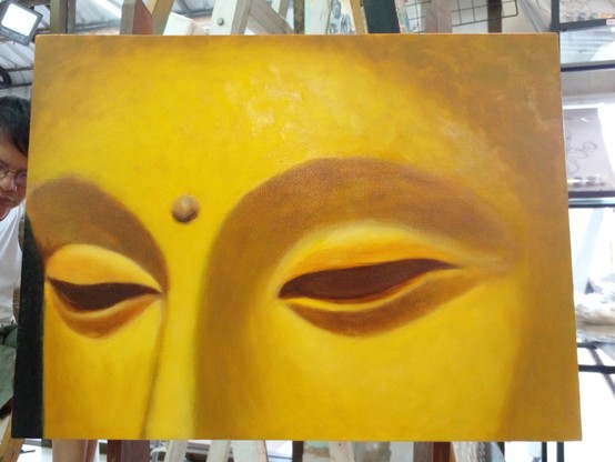 a painting of a close up of the forehead down to the lower bridge of the node of the Buddha, he is gold-colored, a small orb between his eyes, his eyes are filled with shadow, no eyeballs inside