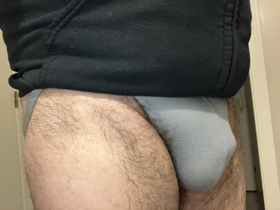 Grey bulge under hoodied torso