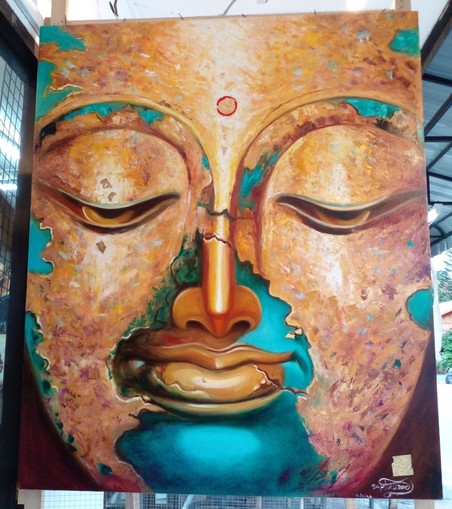 a painting of a face, the eyes looking downward, a relaxed expression, sections of it are in gold, the forehead, nose, parts of cheeks and the lips are gold; the chin, and parts of the eyebrows and cheeks and jawline are done in dark turquoise , there is a circle between the eyes
