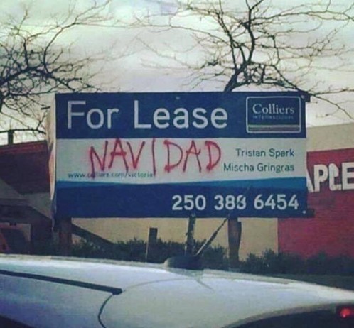 A "For Lease" sign with "NAvidad" spray painted on it