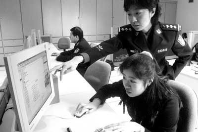 event evaluations: black and white photograph of a standing Chinese official pointing to the screen of a computer used by a seated civilian. Photo attribution: Flickr user charleshope