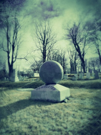 Ponderous polished marble sphere seems to hover above haunted burial grounds