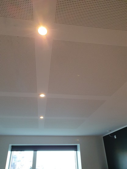 Three recessed lights on a white ceiling
