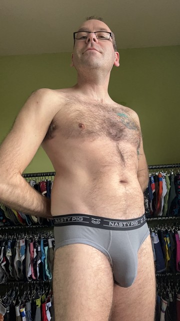 Hairy gay guy wearing grey Nasty Pig briefs with black waistband