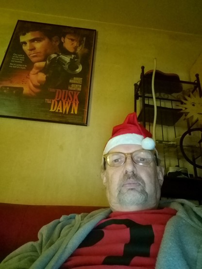 Yours truly with a too small Santa hat glowing with Christmas cheer...
Waiting in vain
For a bullet in the brain
From George