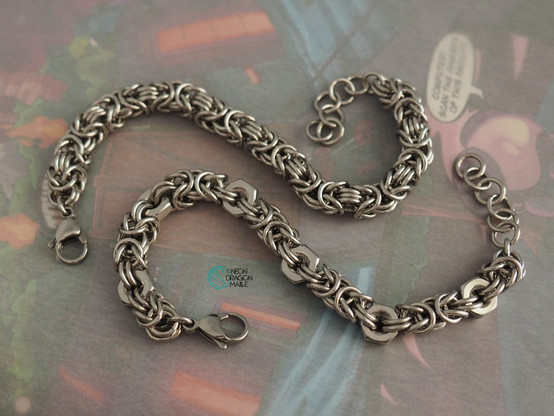 two stainless steel byzantine bracelets, one of which is made in part with hex nuts.