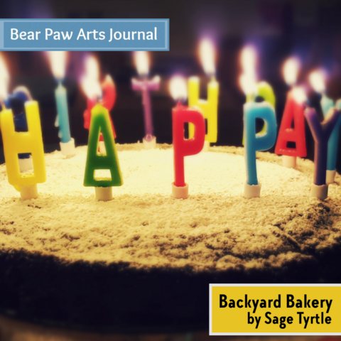 Birthday cake with candles reading "happy birthday".