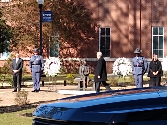 Rosalynn Carter's family pays tribute to her statue in front of the Rosalynn Carter Health Sciences Complex at Georgia Southwestern State University.