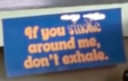 Sign in office "If you smoke around me, don't exhale" in a scene of "Bill & Ted's Excellent Adventure"