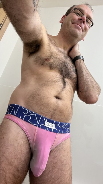 Hairy gay guy wearing peach / pink SUKREW briefs with blue waistband