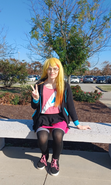 A picture of me dressed in cosplay as Asahi Lina but wearing thigh-high socks