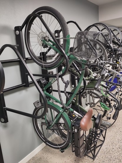 A Townie bike on a storage rack, with other bikes behind it.