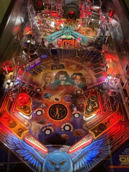 Detail of the Rush pinball machine featuring airbrush-style caricatures of the band.