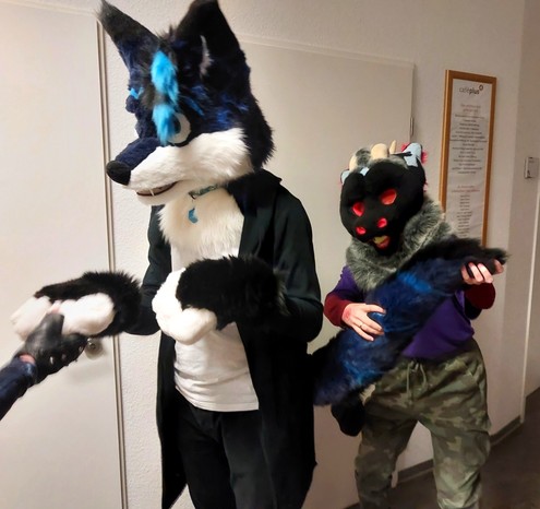 This picture is similar to the previous one and shows me allowing someone, who is not visible in it, to hold my paw, while the derg still has fun with my tail xD