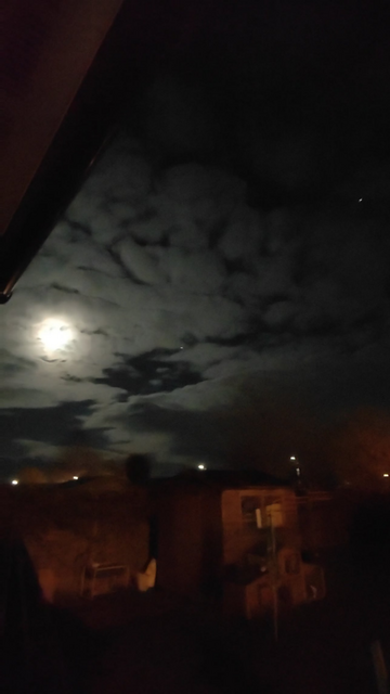 Was having a cigarette out of my back garden when I saw a bright light hovering near the moon. Must have been there a good 20 seconds. I thought it was a star or planet but then it started to move really fast and then disappeared.