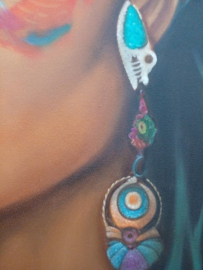 a close-up of the woman's jawline , her large ornate heavy earring