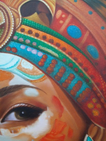 a close up of her eye and upper cheek and side of her forehead and a section of the headdress on her head
