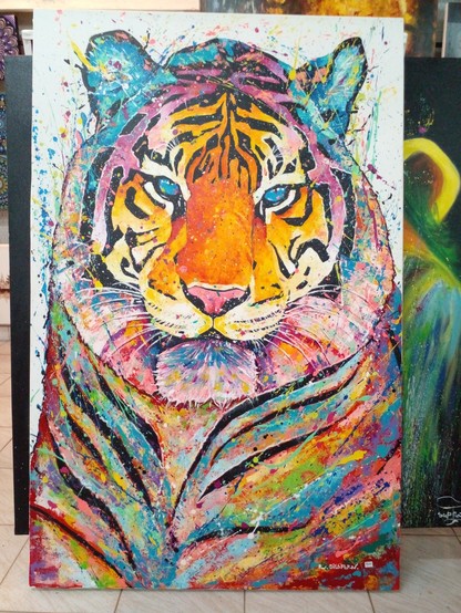 a painting of a tiger, it is tall horizontally, its stripes are black and the space between them is filled in with vibrant, splattered bright neon colors