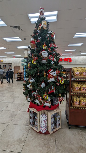 A Christmas tree inside the Buc-ee's gas station. It's covered in ornaments with the Buc-ee's beaver mascot on it.