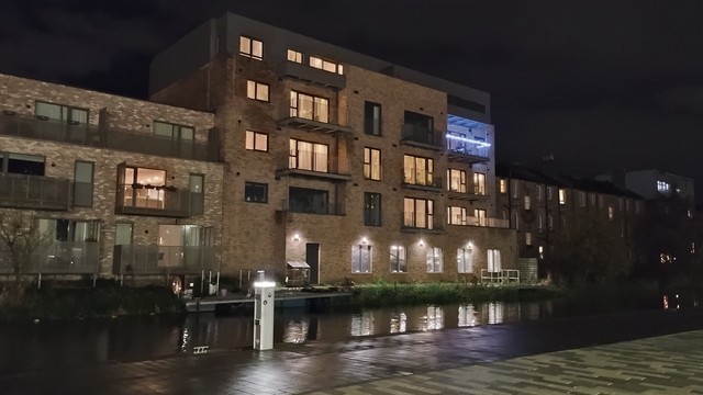 Modern apartments at night by the Union Canal, lights reflecting in the dark waters