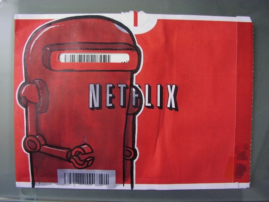 Building conference programs: A photograph of Netflix's iconic red envelope used to mail DVDs.