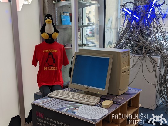 a penguin toy, t shirt, computer and linux on it