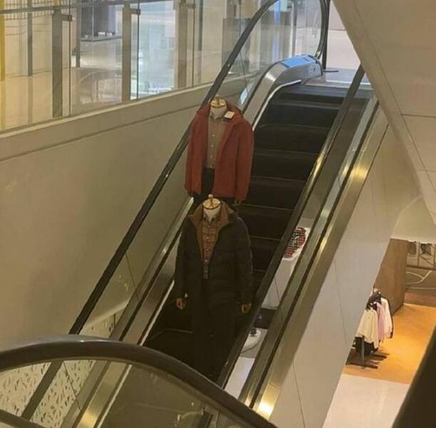 Dummies without heads go down escalator