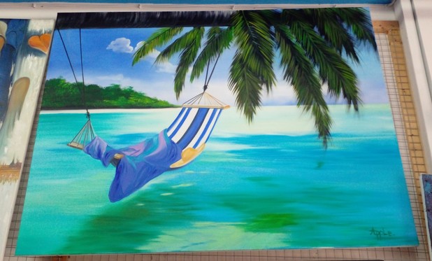 a painting of a hammock over a lagoon on a beach, the sand in the distance is white, there are palm fronds hanging down, the water aqua colored, the hammock is stripes of white, blue, and purple, the towel on it blue