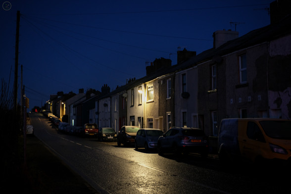 Early morning shot of village street with frosted cars and street lights