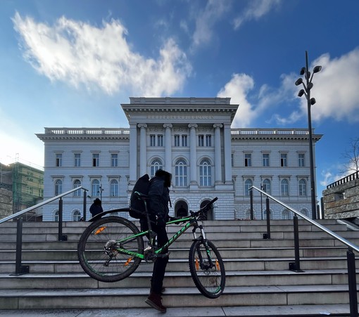 Foto des GebÃ¤udes der Bundesbahndirektion in #Wuppertal
Ein Mann trÃ¤gt sein Fahrrad die Treppen hoch zum Vorplatz des GebÃ¤udes
