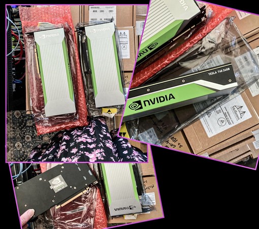 Two passively cooled GPUs, made by NVIDIA, model T40 with 24GB vRAM. The cards are sitting atop various server component boxes.