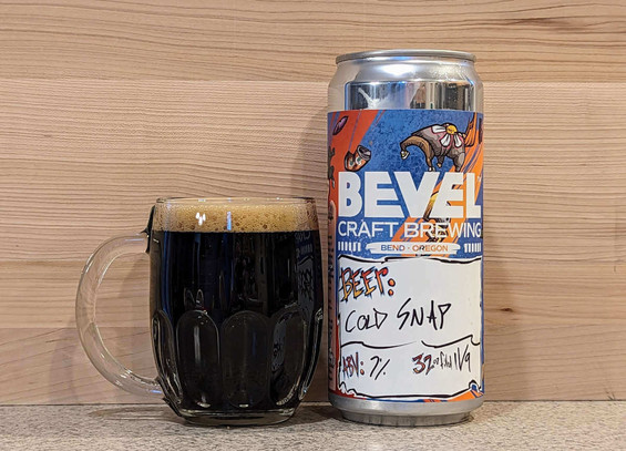 A mug Cold Snap Mexican Hot Chocolate Stout poured from a crowler (a 32 fluid ounce can that holds beer) from Bevel Craft Brewing of Bend, Oregon