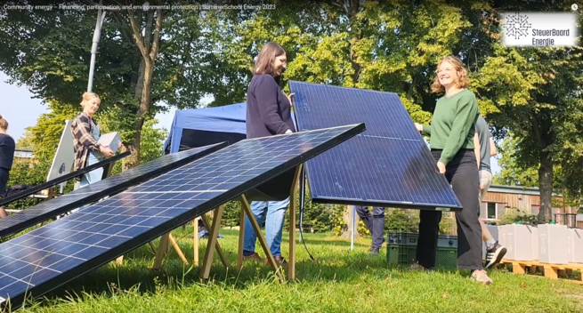 Participants of the summer school carrying solar panels