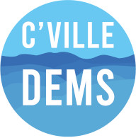 Logo of the Cville Dems (local chapter of the Democratic Party of Virginia) showing the words "C'Ville Dems" in tall all-caps white letters against a blue background of the Blue Ridge Mountains.