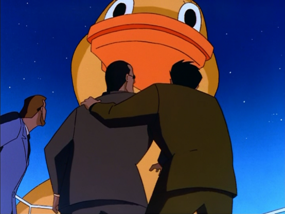 an image from the episode, mobsters stand below a giant toy duck, looking up at it in amazement