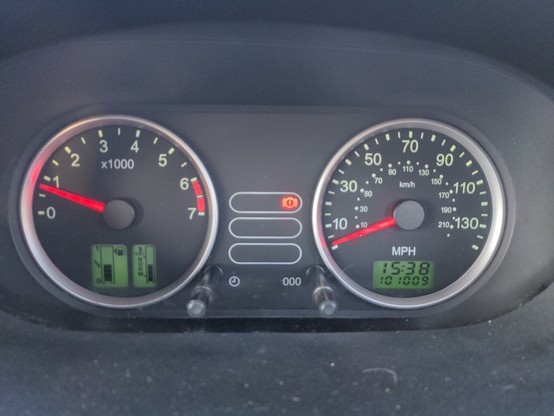 The dashboard of my Fiesta when I finished my journey. The time reads 15:38 and the odometer reads 101,009 miles. The fuel gauge is exactly half way down.