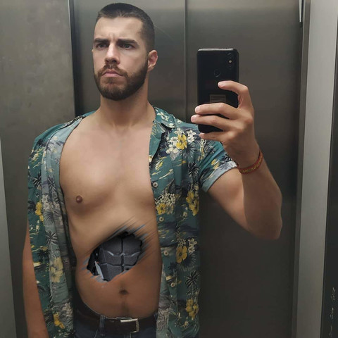 An android with an unbuttoned Hawaiian shirt has a smooth chest and is taking a selfie in an elevator with its abdomen damaged. Under the broken synthetic skin is metallic robotic abs