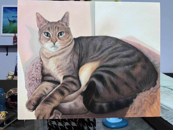 a painting of a cat. laying in a soft round bed, the background is light tan, the cat is heavy, it looks at the viewer with green eyes, it has dark brown and tan stripes on it